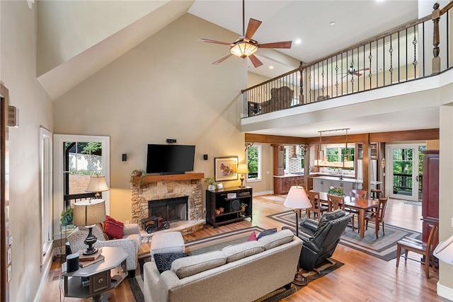 328 Grand Overlook Dr, Seneca, SC 29678 - living room with high vaulted ceiling, wood finished floors, a ceiling fan, a fireplace, and recessed lighting