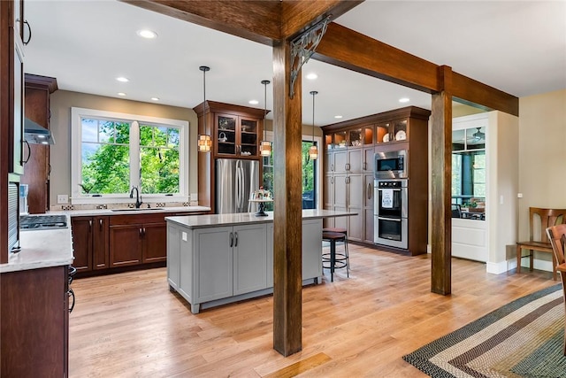 328 Grand Overlook Dr, Seneca, SC 29678 - kitchen with stainless steel appliances, a kitchen island, a sink, a breakfast bar area, and recessed lighting