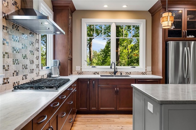 328 Grand Overlook Dr, Seneca, SC 29678 - kitchen with appliances with stainless steel finishes, wall chimney exhaust hood, a sink, backsplash, and light wood finished floors