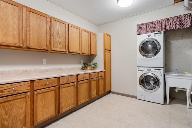 328 Grand Overlook Dr, Seneca, SC 29678 - washroom featuring stacked washing machine and dryer, cabinet space, light tile patterned floors, and crown molding