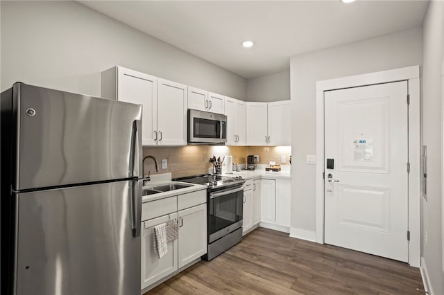 kitchen featuring white cabinets, sink, dark wood-type flooring, and appliances with stainless steel finishes