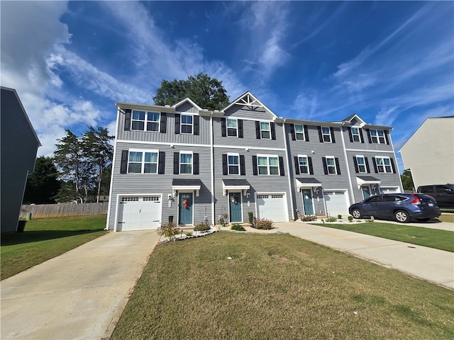 townhome / multi-family property featuring a garage and a front lawn