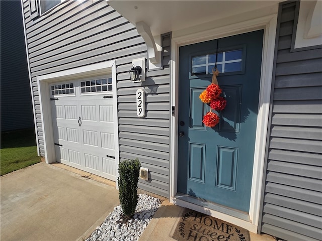 view of exterior entry with a garage