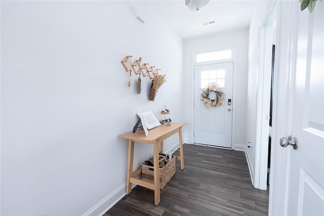 entryway with dark hardwood / wood-style flooring