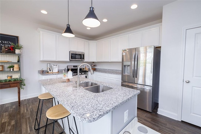 kitchen with white cabinetry, an island with sink, stainless steel appliances, and sink