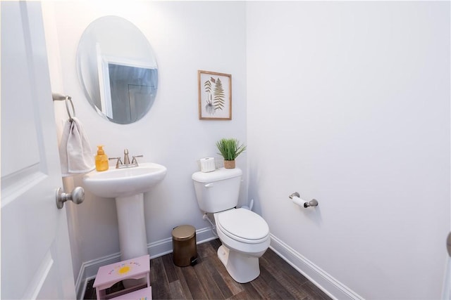 bathroom featuring sink, wood-type flooring, and toilet