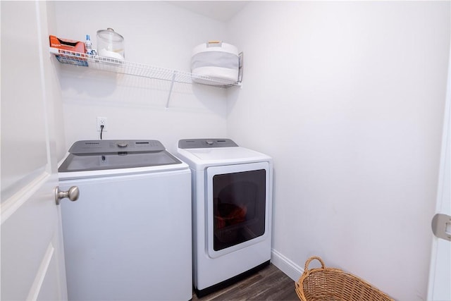 laundry room with dark hardwood / wood-style floors and washer and clothes dryer