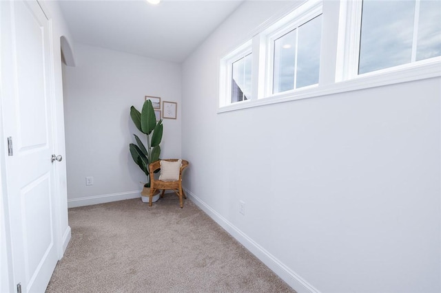 corridor with light colored carpet