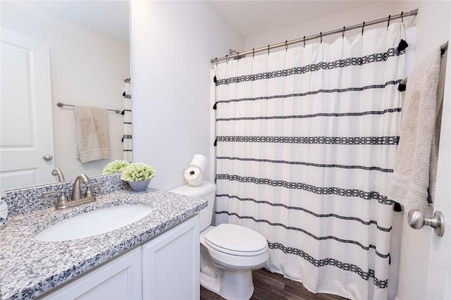 bathroom with vanity, toilet, and hardwood / wood-style floors