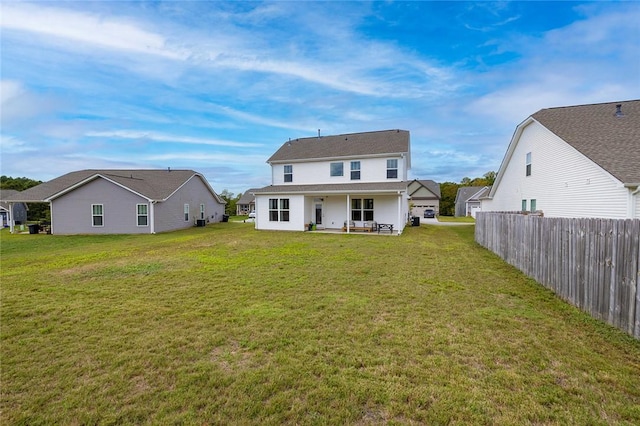 back of property with a patio and a lawn