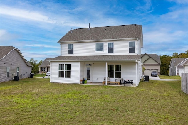 rear view of house featuring a yard, central AC, and a patio area