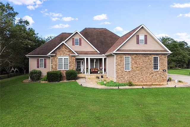 craftsman inspired home with a front yard and a porch