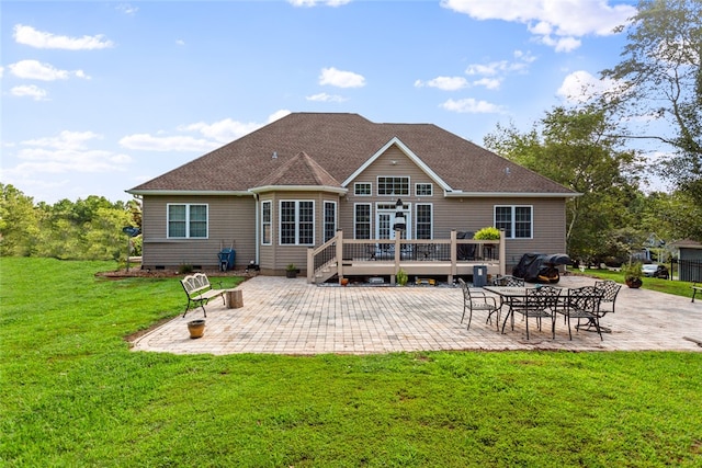 rear view of property with a yard and a patio area