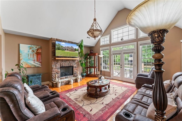 516 Serria Way, Seneca, SC 29678 - living room with a stone fireplace, high vaulted ceiling, wood finished floors, and baseboards