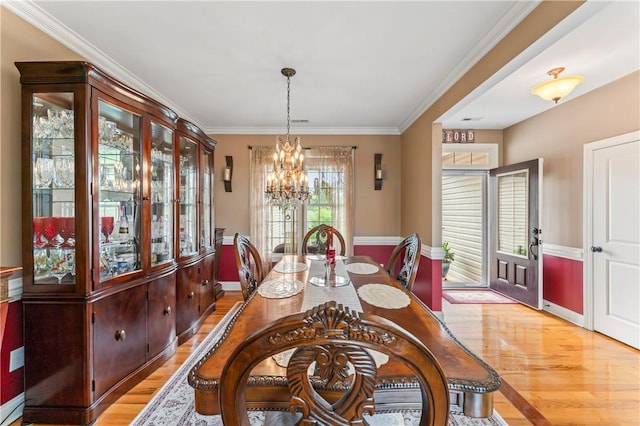 516 Serria Way, Seneca, SC 29678 - dining space featuring light wood-style floors, a chandelier, and ornamental molding