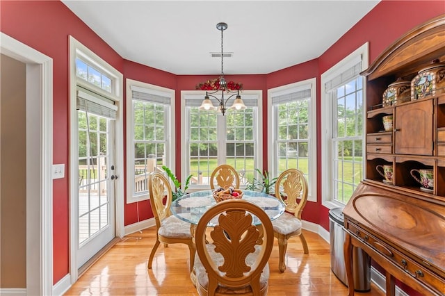 516 Serria Way, Seneca, SC 29678 - dining space with baseboards, light wood-style floors, and a chandelier