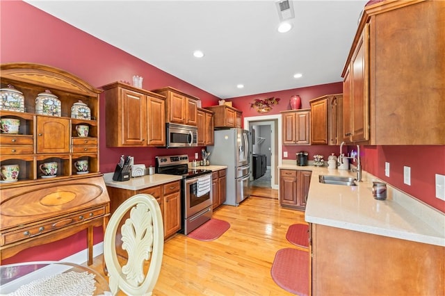 516 Serria Way, Seneca, SC 29678 - kitchen featuring stainless steel appliances, a sink, light wood-type flooring, brown cabinets, and recessed lighting