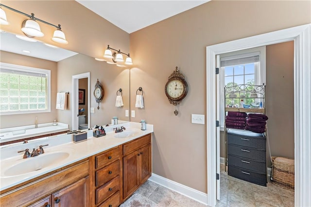 516 Serria Way, Seneca, SC 29678 - bathroom featuring baseboards, double vanity, toilet, and a garden tub