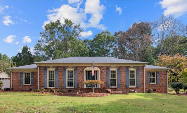 ranch-style home featuring a garage and a front lawn