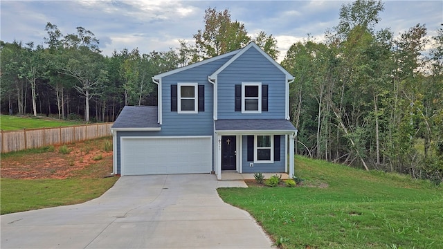 view of front of home featuring a front yard and a garage