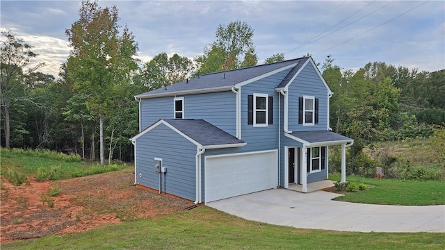 front facade featuring a front lawn and a garage