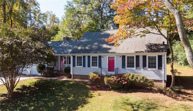 cape cod-style house with a garage and a front lawn