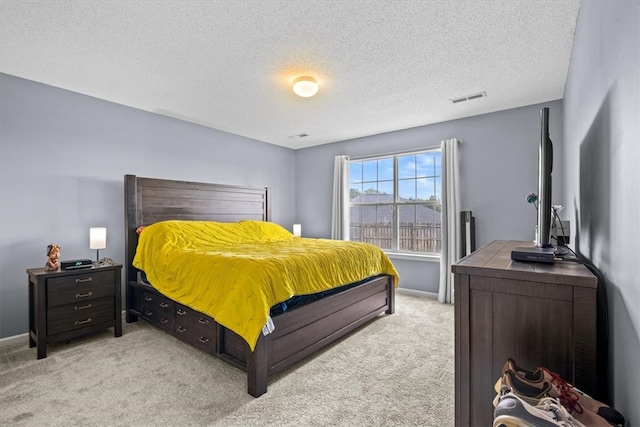 carpeted bedroom featuring a textured ceiling