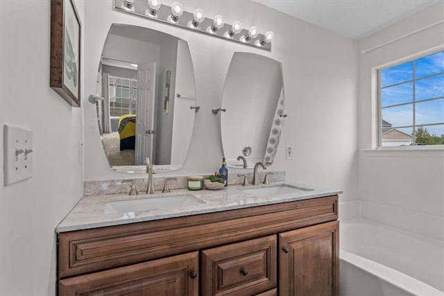 bathroom featuring vanity and a tub