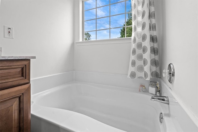 bathroom with a tub to relax in and vanity