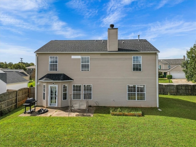 rear view of house featuring a patio and a yard