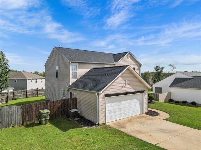 view of home's exterior featuring a garage, a lawn, and central air condition unit