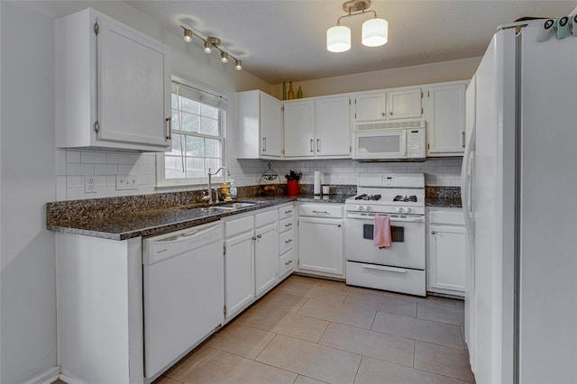 kitchen with white appliances, white cabinetry, and sink