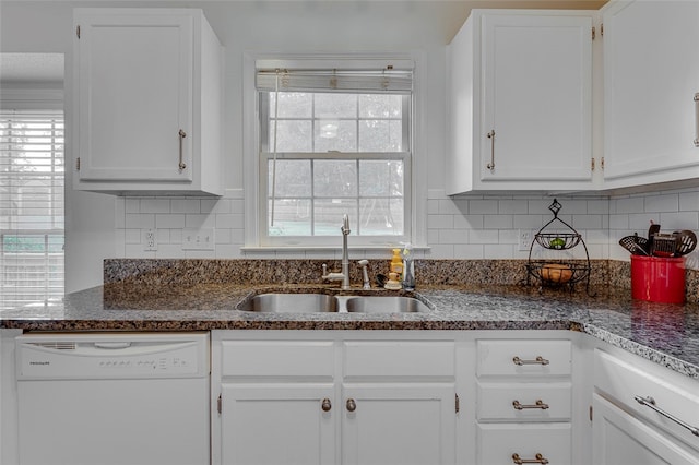 kitchen with decorative backsplash, white cabinets, white dishwasher, and sink