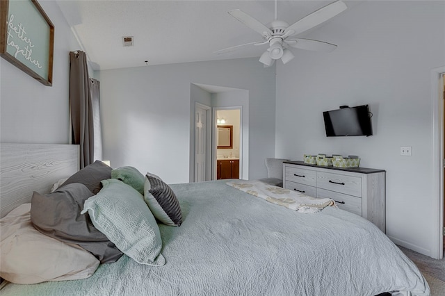 carpeted bedroom featuring ceiling fan, lofted ceiling, and connected bathroom