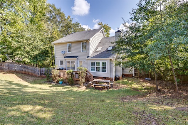 back of property featuring a yard and a deck