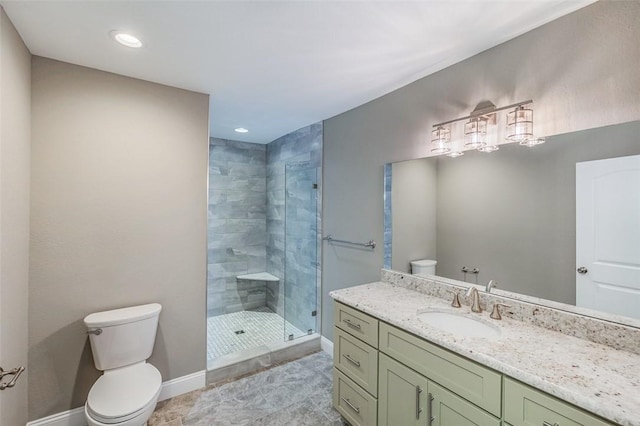 bathroom with an enclosed shower, vanity, and toilet