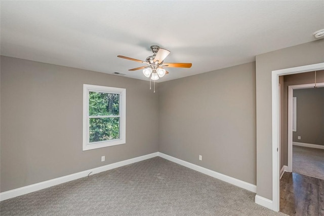 carpeted spare room featuring ceiling fan