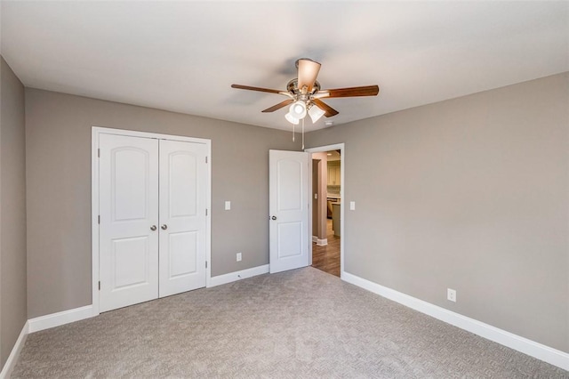 unfurnished bedroom with ceiling fan, a closet, and carpet