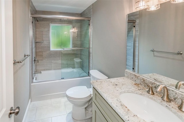 full bathroom with tile patterned flooring, vanity, shower / bath combination with glass door, and toilet