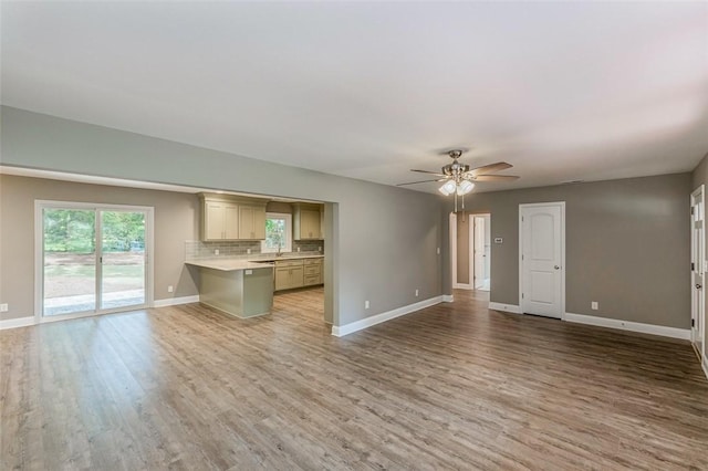 unfurnished living room featuring ceiling fan and light hardwood / wood-style flooring