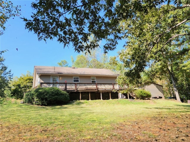 back of property featuring a lawn and a deck