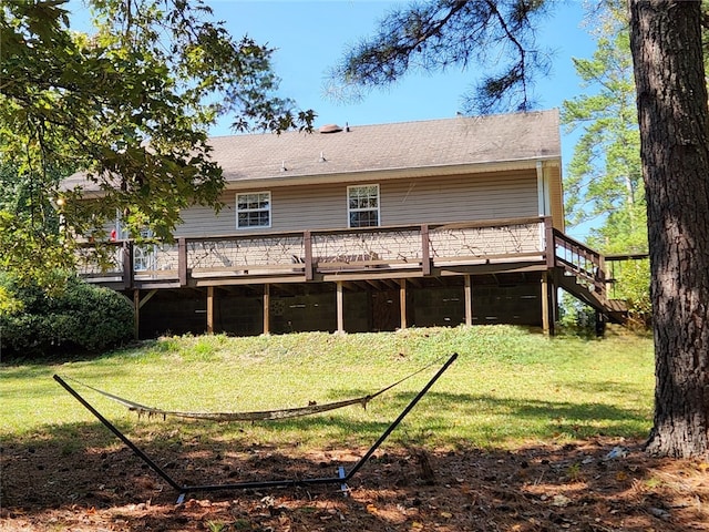 back of property with a lawn and a deck