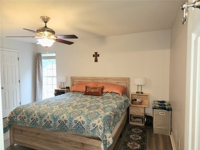 bedroom with a textured ceiling, ceiling fan, and hardwood / wood-style flooring