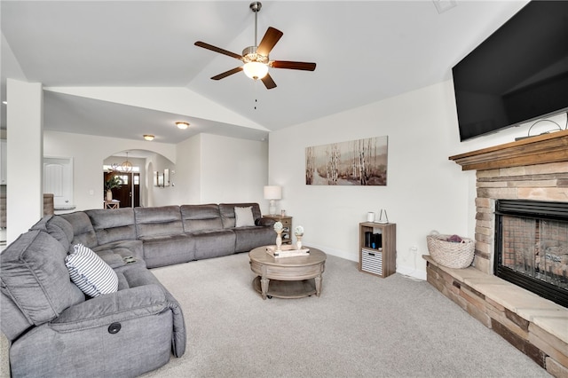 carpeted living room with lofted ceiling, ceiling fan, and a fireplace