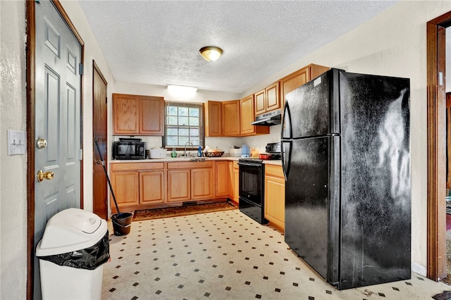 kitchen with a textured ceiling, sink, and black appliances