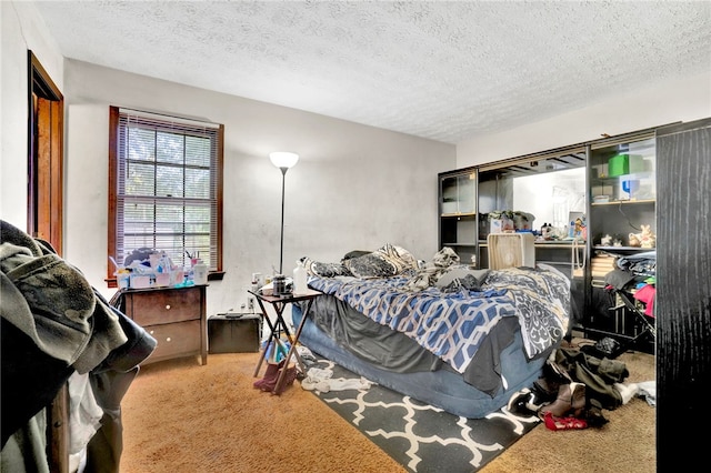 bedroom featuring a textured ceiling and carpet