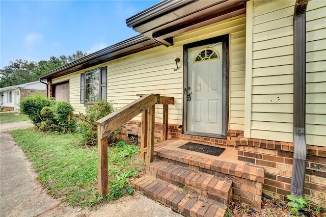 view of exterior entry featuring a garage