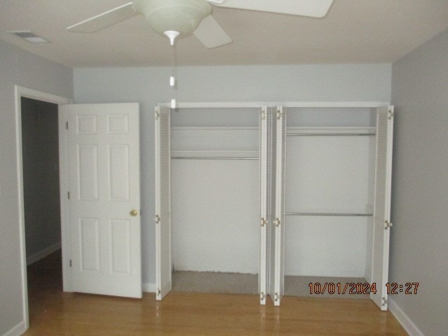 unfurnished bedroom featuring ceiling fan and wood-type flooring