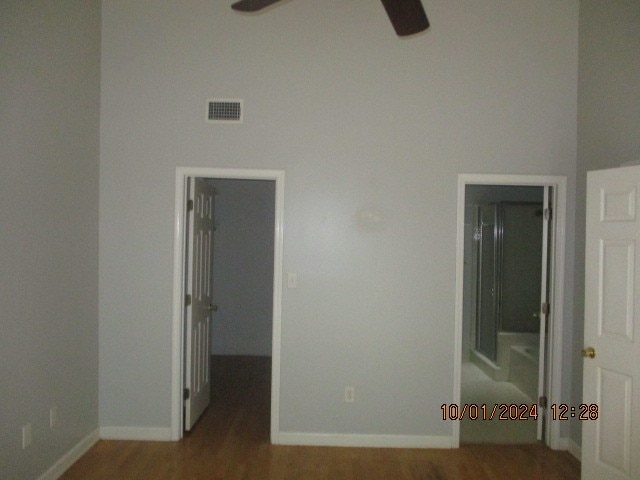 empty room with ceiling fan and wood-type flooring