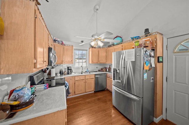 kitchen with ceiling fan, stainless steel appliances, sink, light hardwood / wood-style floors, and light brown cabinetry